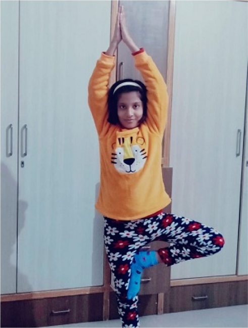 A person and a child doing yoga indoors