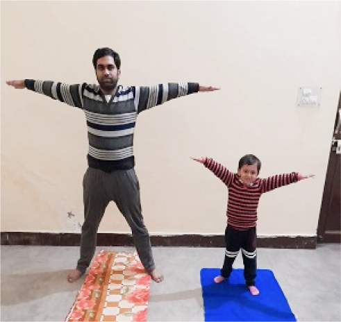 A person and a child doing yoga indoors